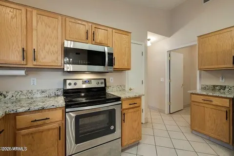 a kitchen with cabinets stainless steel appliances and a sink