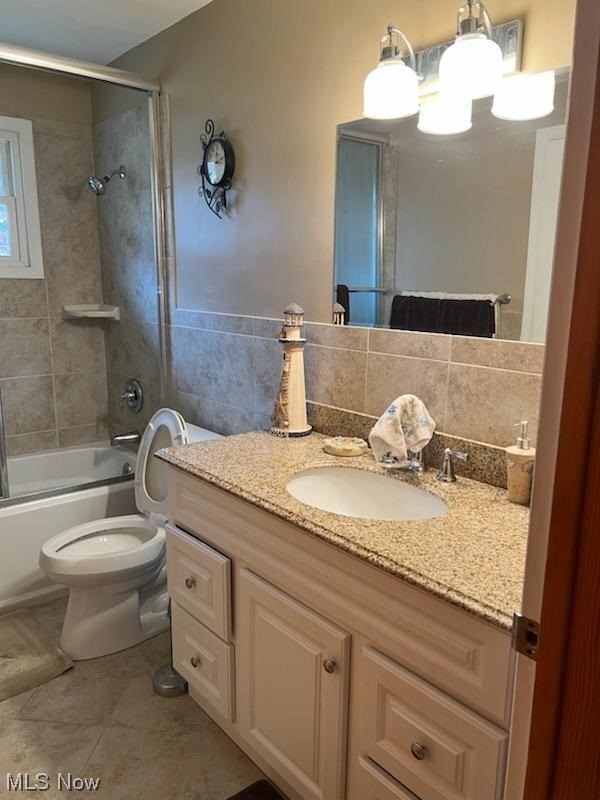 932 Pinecrest Road Girard, OH 44420 - Photo 17 of 25 Full bathroom featuring toilet, vanity, tile flooring, backsplash, and tiled shower / bath