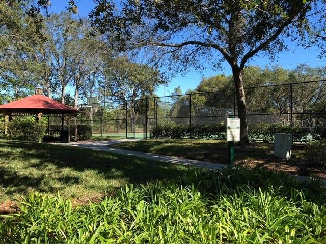 8521 Crystal Cove Loop Kissimmee, FL 34747 - Photo 20 of 23 a backyard of a house with lots of green space and fountain