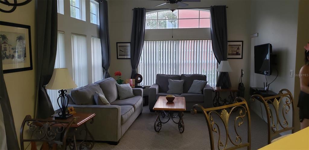 8521 Crystal Cove Loop Kissimmee, FL 34747 - Photo 2 of 23 a living room with furniture and a flat screen tv