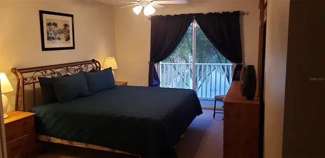 a bed sitting in a bedroom next to a wooden cabinet