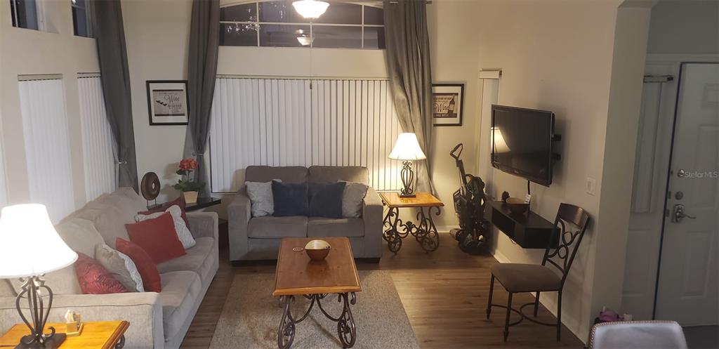 8521 Crystal Cove Loop Kissimmee, FL 34747 - Photo 5 of 23 a living room with furniture a flat screen tv and a window