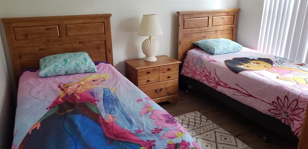 8521 Crystal Cove Loop Kissimmee, FL 34747 - Photo 7 of 23 a bedroom with a bed and a dresser