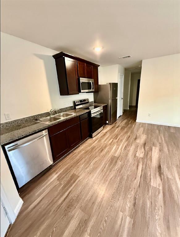 812 South 22nd Street Temple, TX 76501 - Photo 7 of 34 a kitchen with stainless steel appliances granite countertop a stove a sink and a microwave