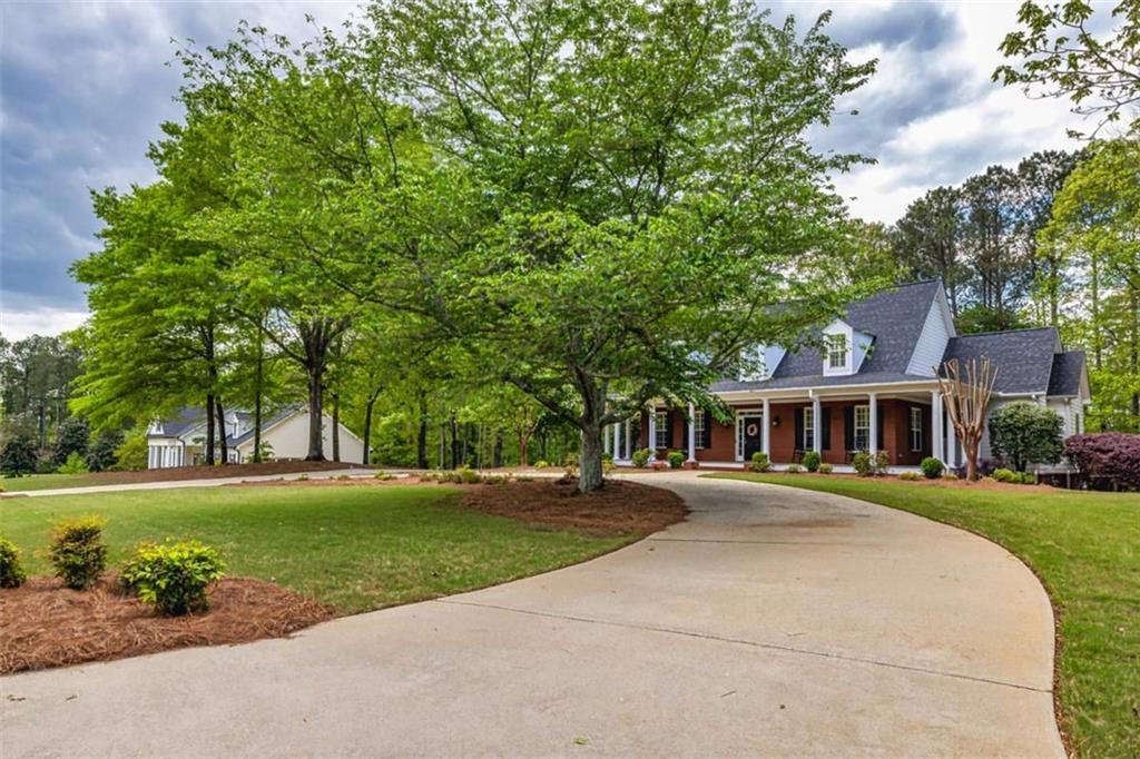 20 Jasmine Court Newnan, GA 30265 - Photo 70 of 72 a front view of a house with a garden