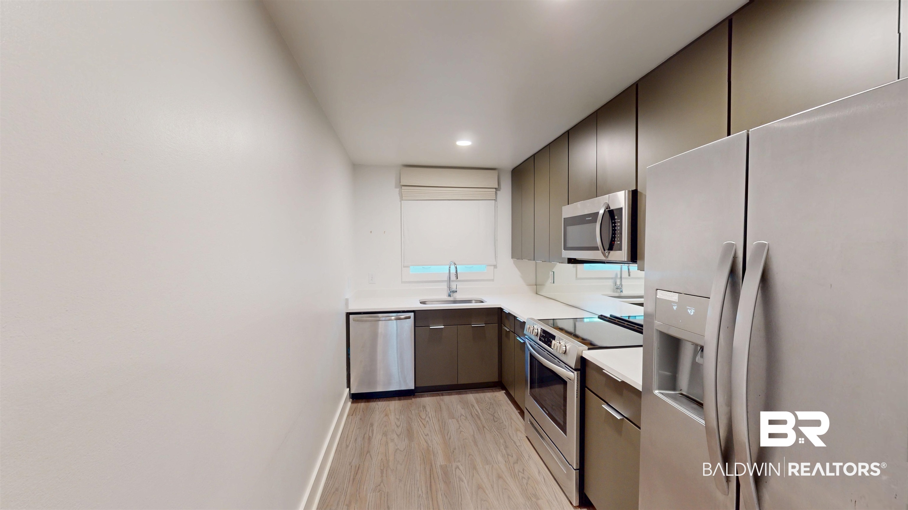 3655 Old Shell Road, Unit 219 Mobile, AL 36608 - Photo 7 of 25 Kitchen featuring stainless steel appliances, modern cabinets, light wood finished floors, and recessed lighting