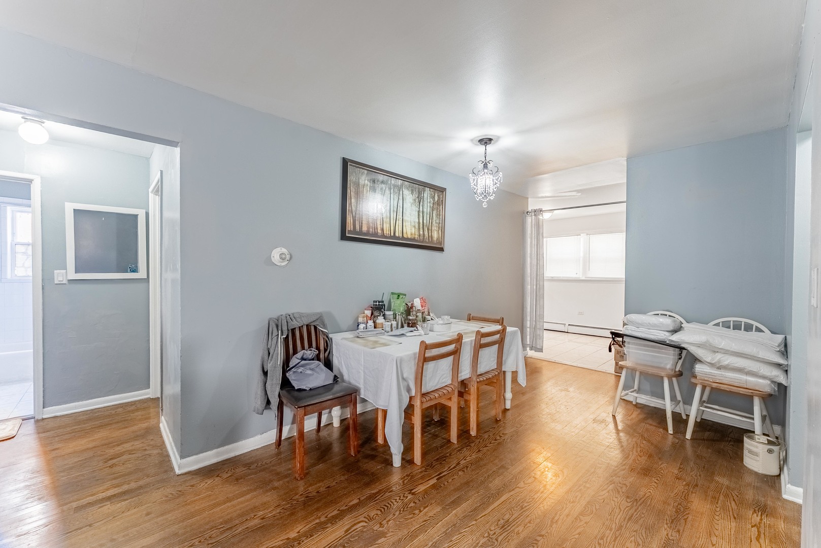 1630 West Chase Avenue, Unit 1N Chicago, IL 60626 - Photo 4 of 11 a view of a dining room with furniture and wooden floor