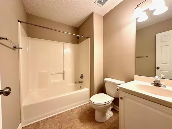 a view of an empty room with wooden walls