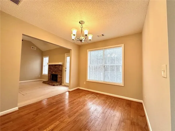 a balcony with wooden floor and trees