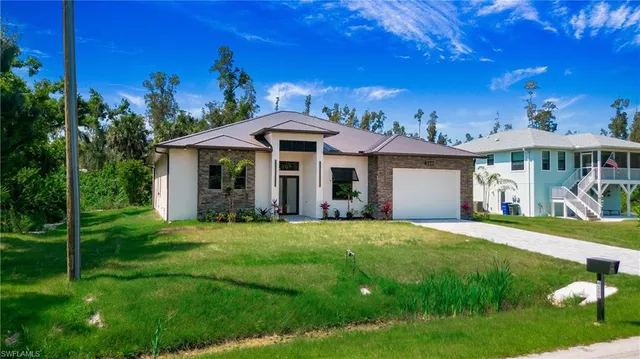 a front view of a house with a garden
