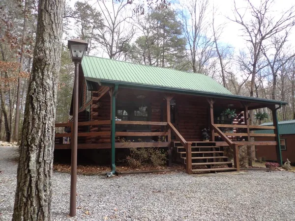 a view of a house with backyard space and wooden deck