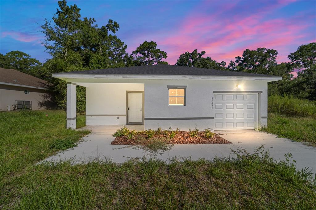 15431 Southwest 41st Street Road Ocala, FL 34481 - Photo 2 of 44 a front view of a house with a yard