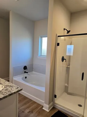 a bathroom with a bathtub and shower