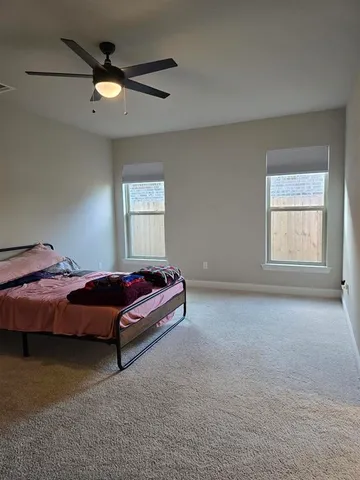 a bed room with a bed and a window