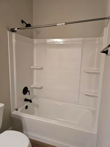 a bathroom with a shower and a toilet