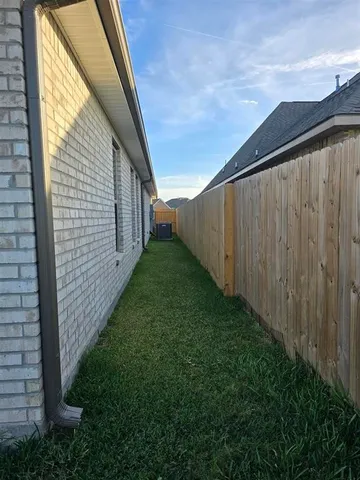 a view of house with backyard