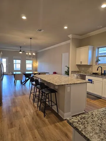 a kitchen with a table chairs refrigerator and microwave