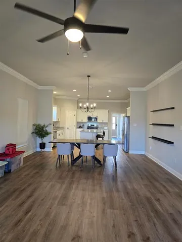 a view of a dining room with furniture and wooden floor
