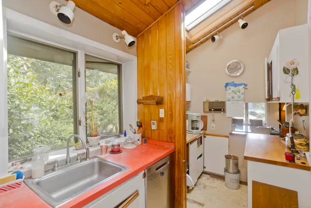 a view of a kitchen with a sink and living room