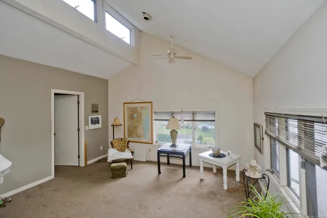 a view of a livingroom with furniture and a window