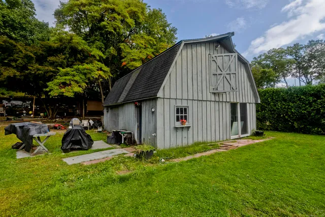 a view of backyard with table and chairs and a small yard