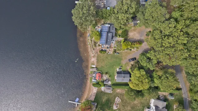 an aerial view of a house with a yard