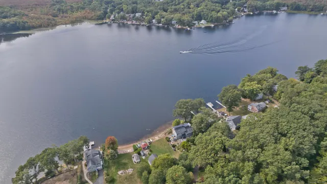 an aerial view of a house with a lake view