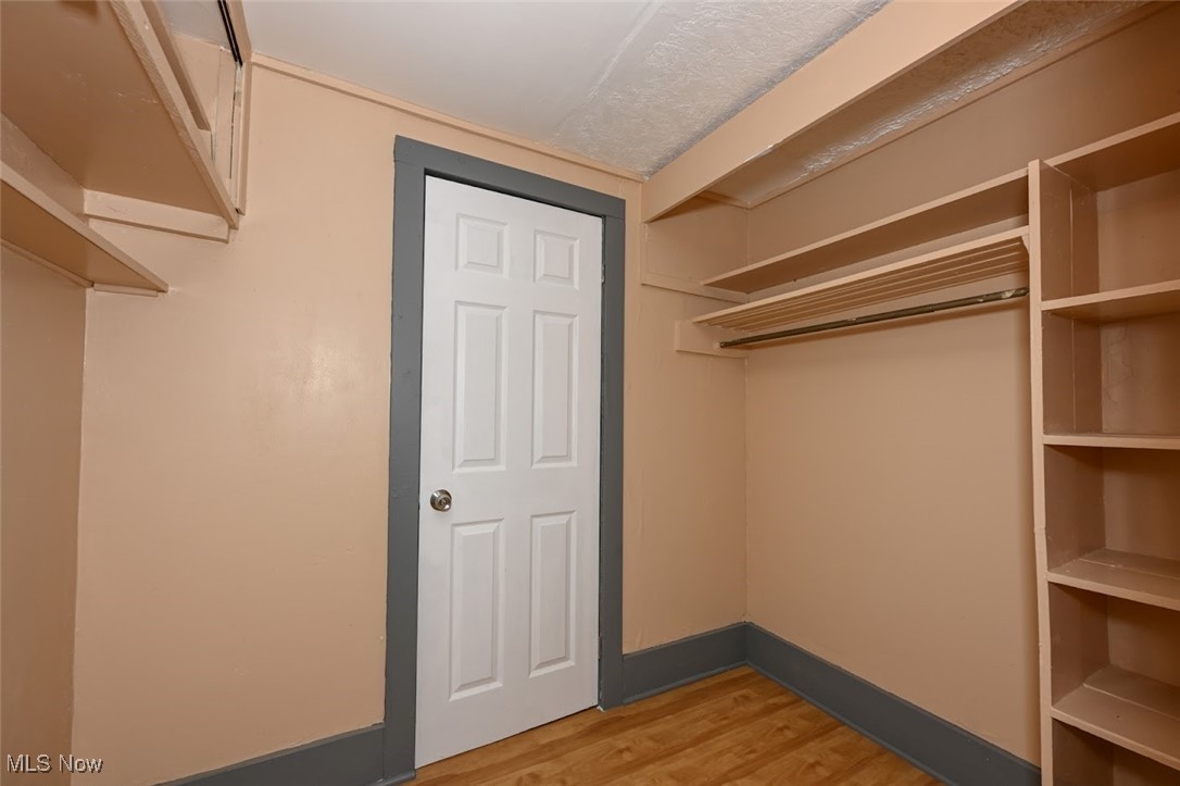 667 Elma Street Akron, OH 44310 - Photo 27 of 42 Walk in closet with light wood-type flooring
