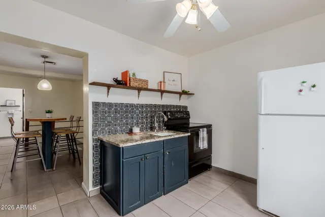 a kitchen with a stove and a refrigerator