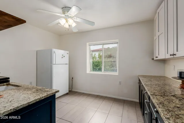 an empty room with a stove and a window