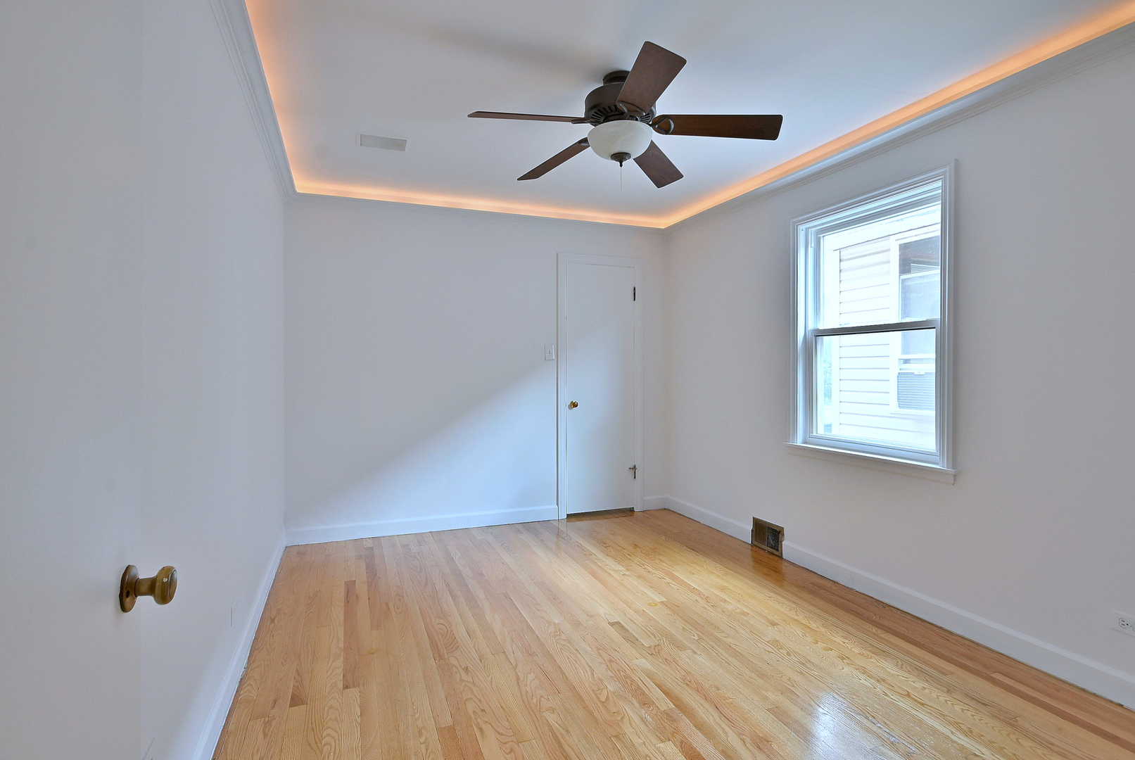 3952 North Oleander Avenue Chicago, IL 60634 - Photo 18 of 34 a view of empty room with wooden floor and fan