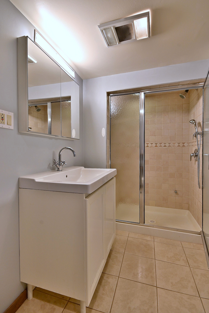 3952 North Oleander Avenue Chicago, IL 60634 - Photo 28 of 34 a bathroom with a sink a toilet and shower