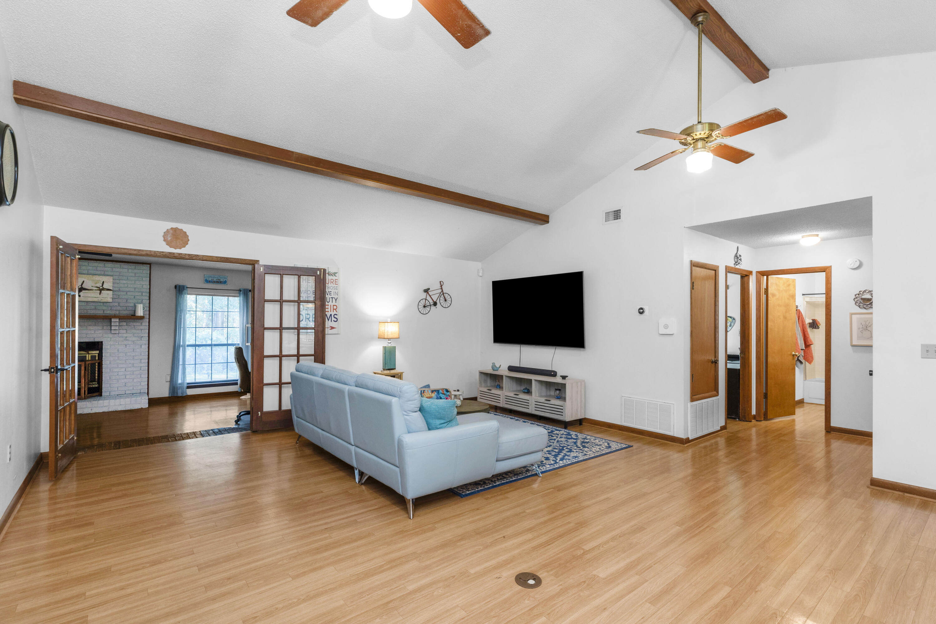 202 Wheeler Place Crestview, FL 32539 - Photo 14 of 40 a living room with furniture wooden floor and a flat screen tv