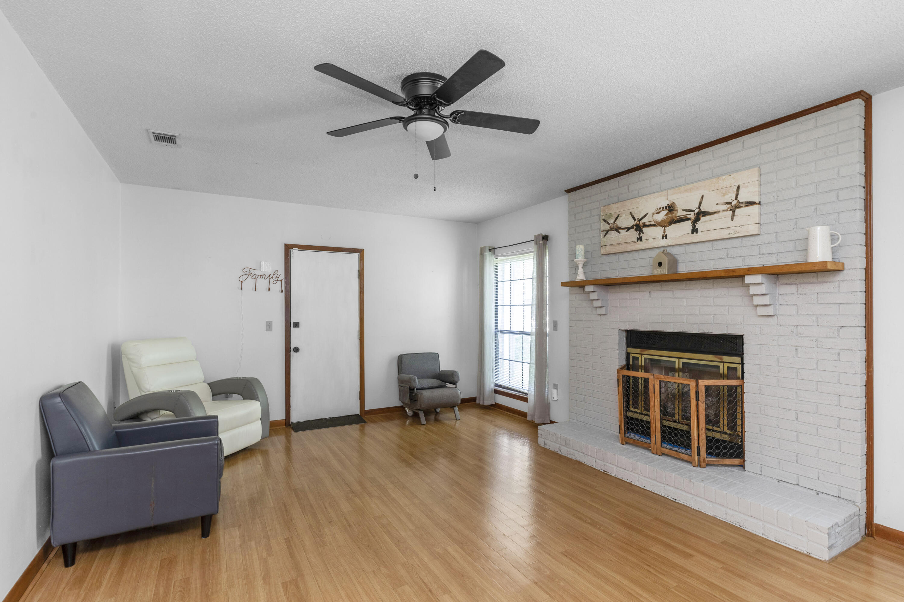 202 Wheeler Place Crestview, FL 32539 - Photo 19 of 40 a living room with furniture and a fireplace