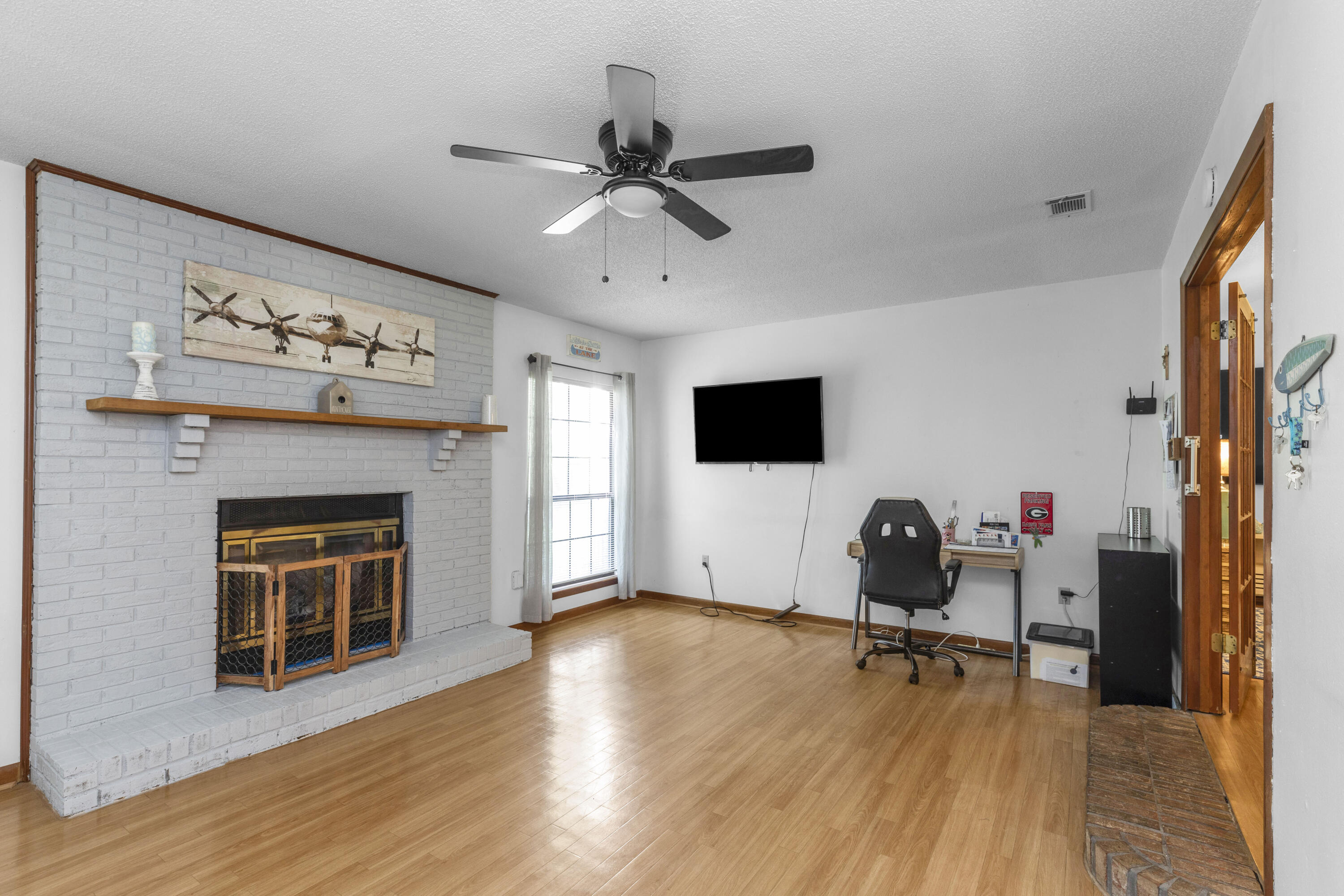 202 Wheeler Place Crestview, FL 32539 - Photo 20 of 40 a living room with furniture and a fireplace