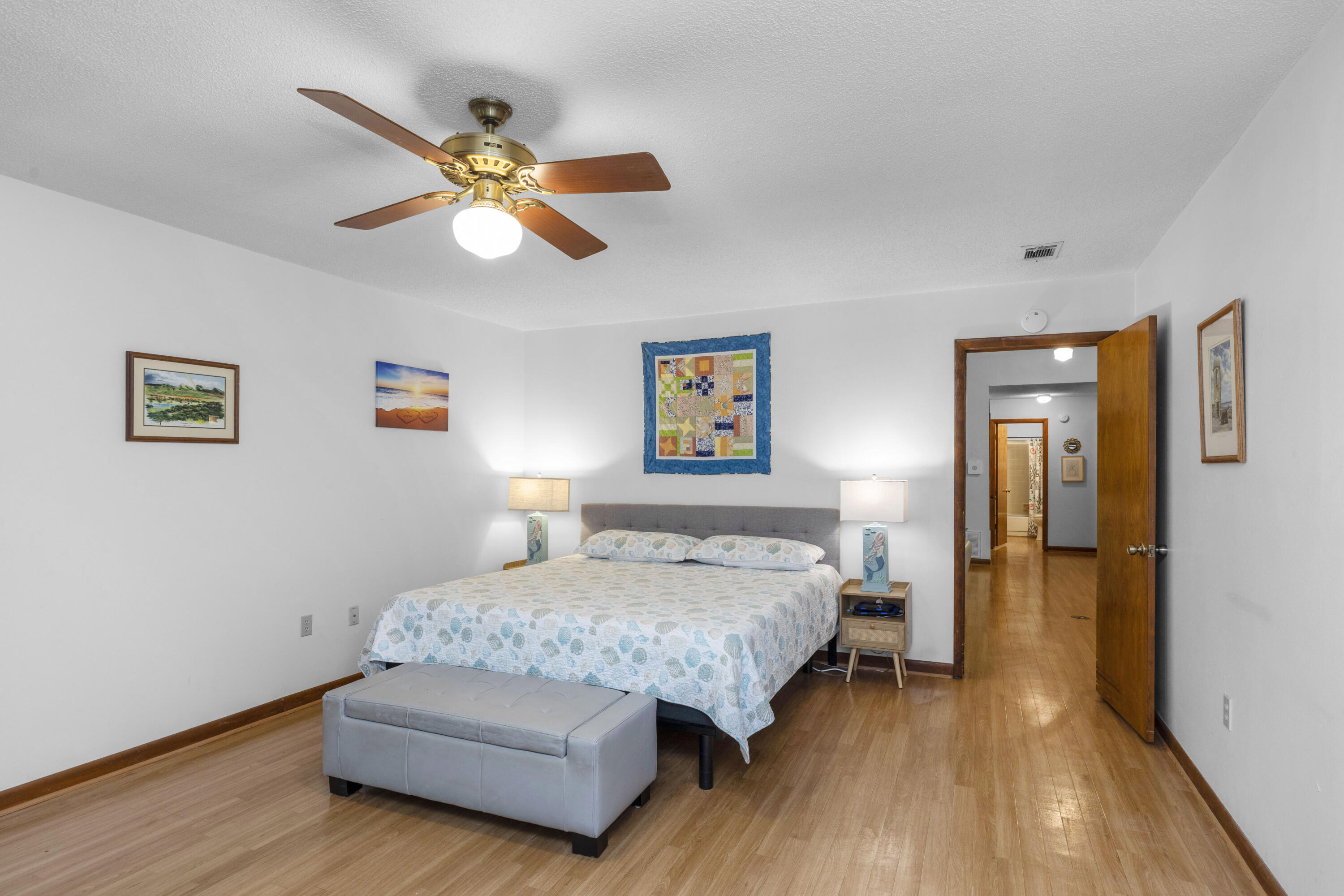 202 Wheeler Place Crestview, FL 32539 - Photo 21 of 40 a bedroom with a bed and a chandelier