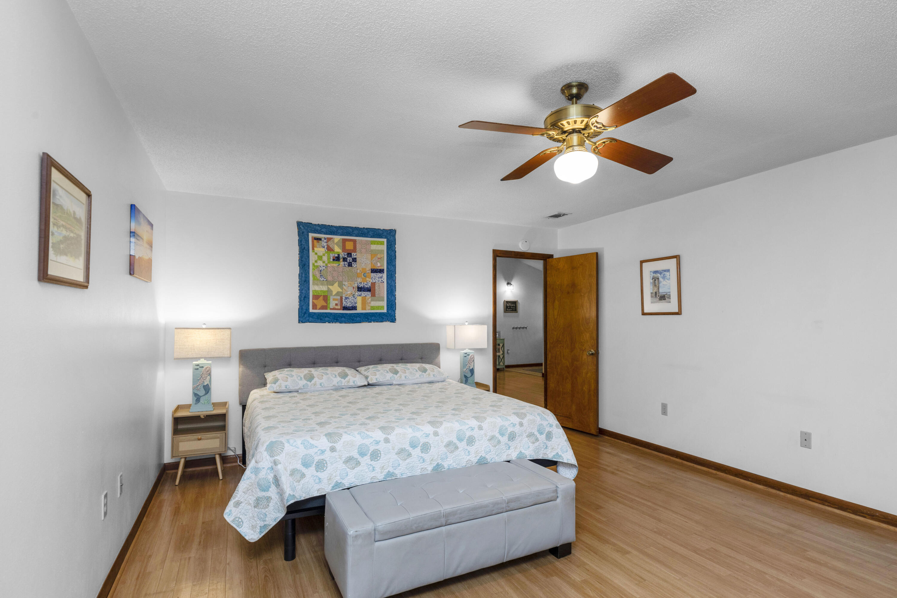 202 Wheeler Place Crestview, FL 32539 - Photo 22 of 40 a bedroom with a bed and a chandelier