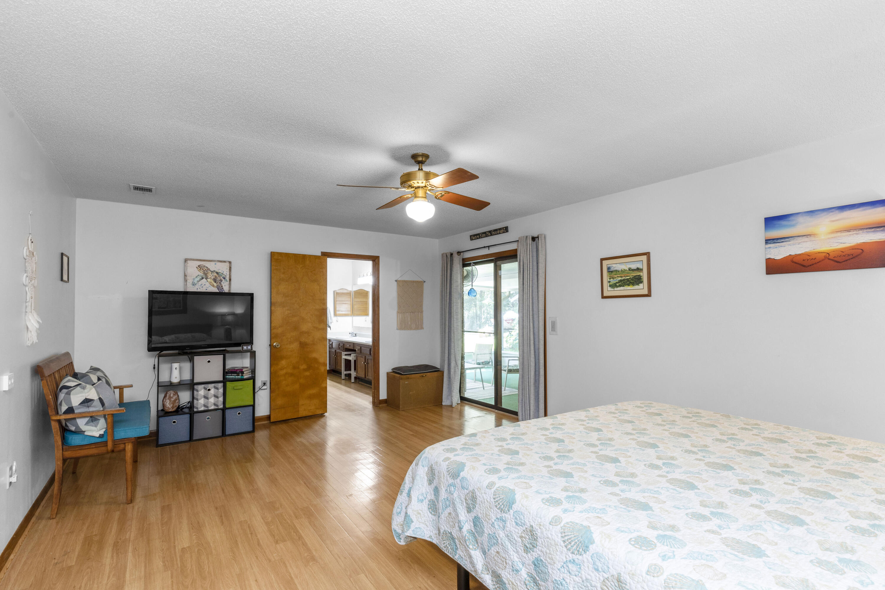 202 Wheeler Place Crestview, FL 32539 - Photo 24 of 40 a bedroom with a bed and a flat screen tv