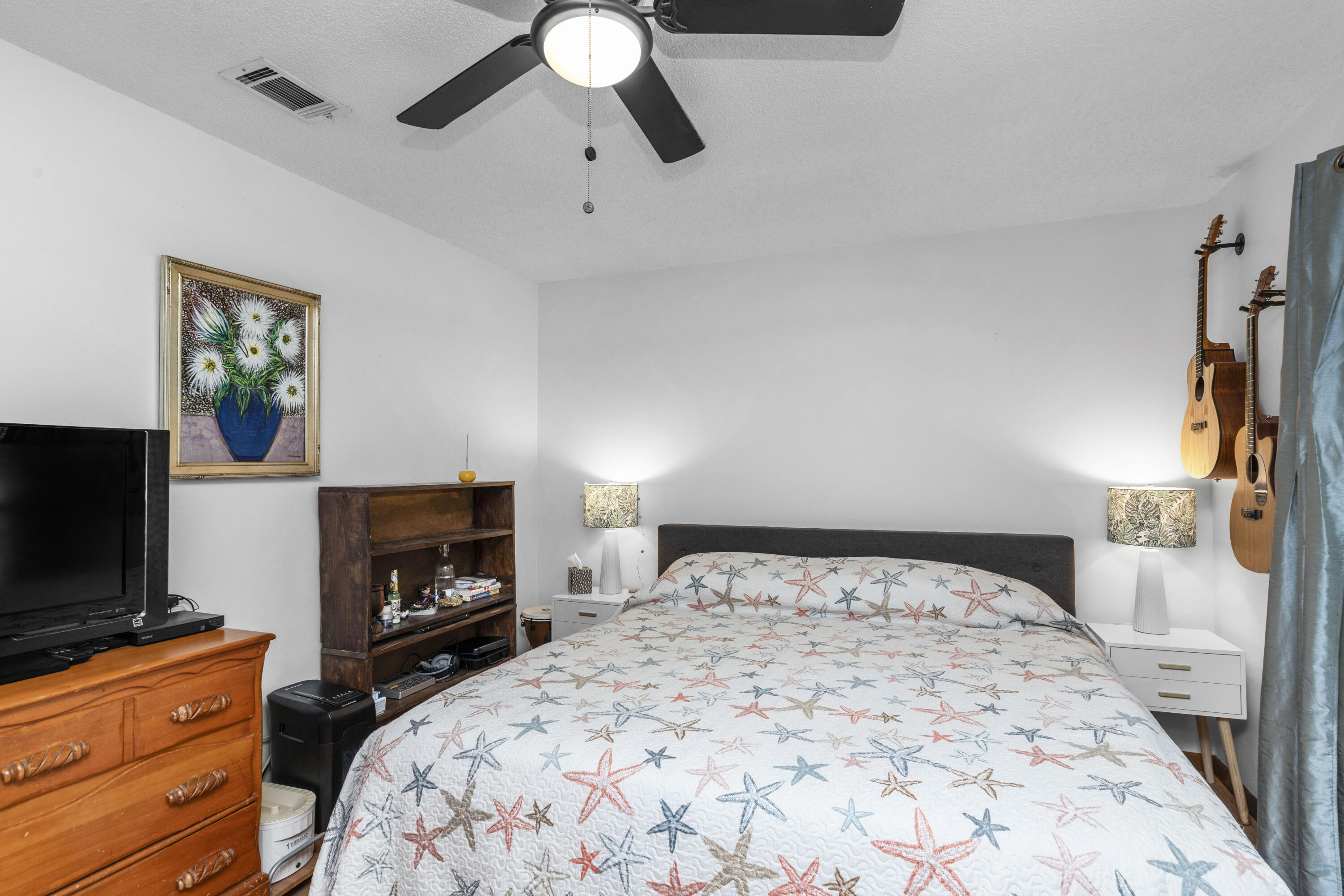 202 Wheeler Place Crestview, FL 32539 - Photo 29 of 40 a bedroom with a bed and a flat screen tv