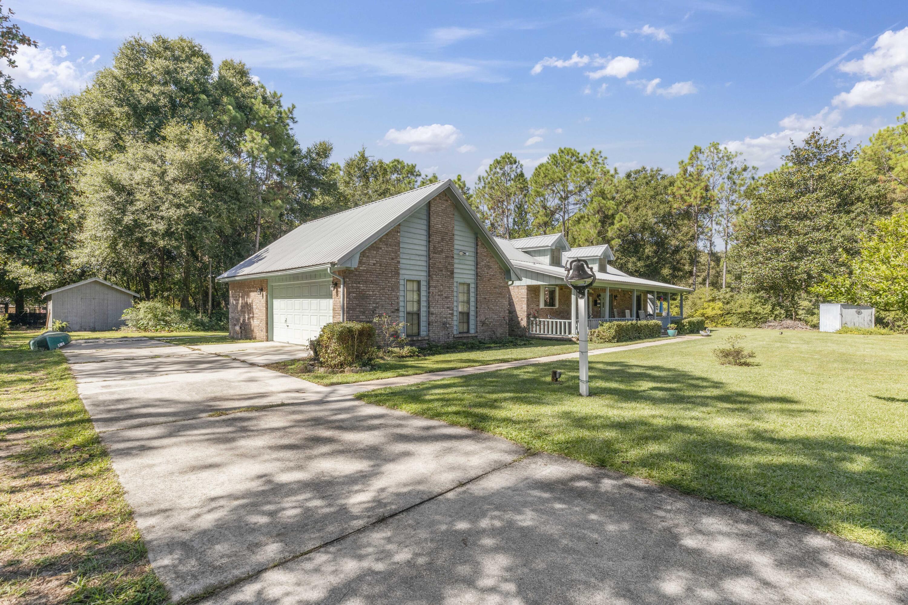202 Wheeler Place Crestview, FL 32539 - Photo 3 of 40 a front view of a house with a yard