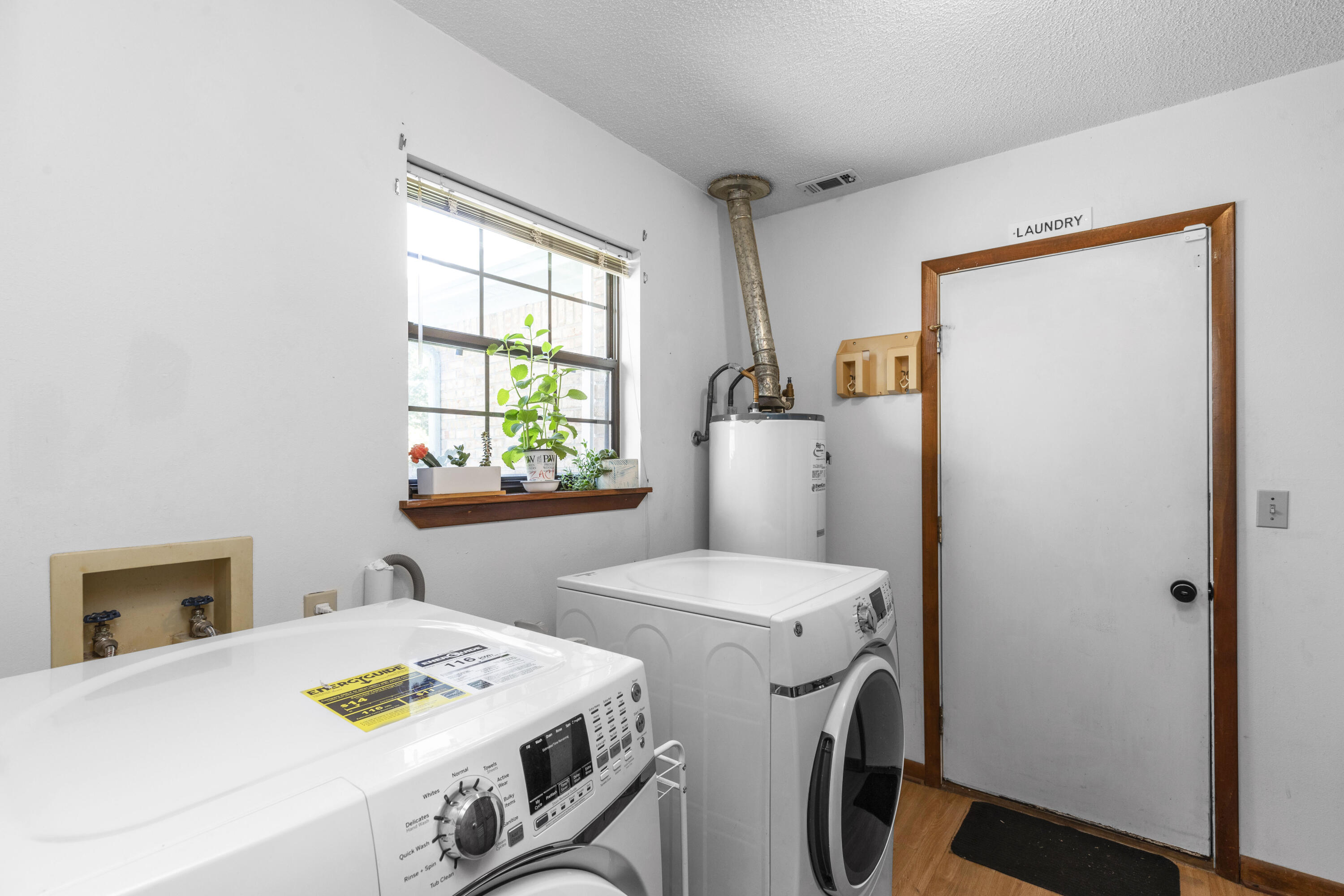 202 Wheeler Place Crestview, FL 32539 - Photo 33 of 40 a view of washer and dryer with kitchen in the background