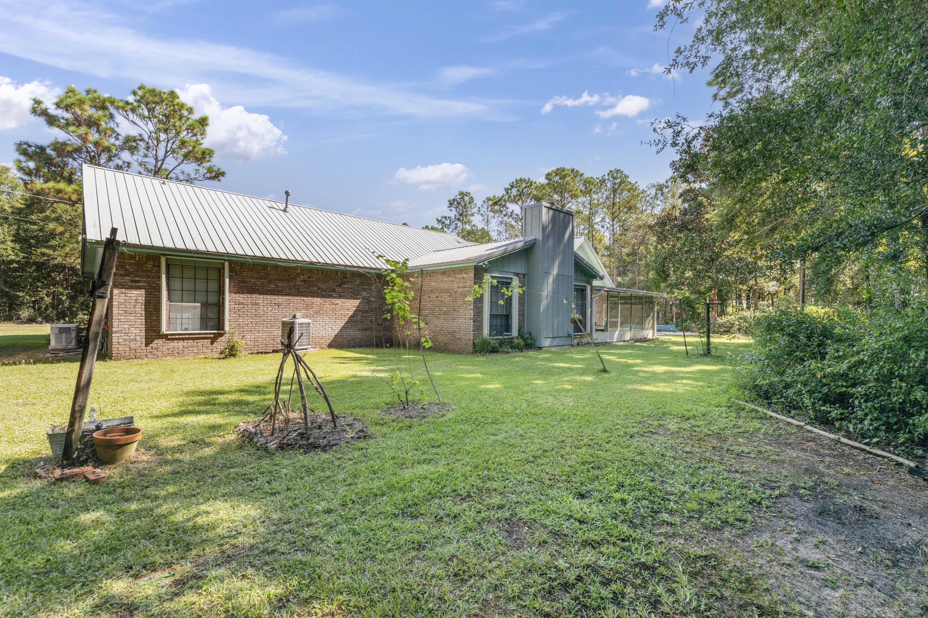 202 Wheeler Place Crestview, FL 32539 - Photo 6 of 40 a house view with a garden space
