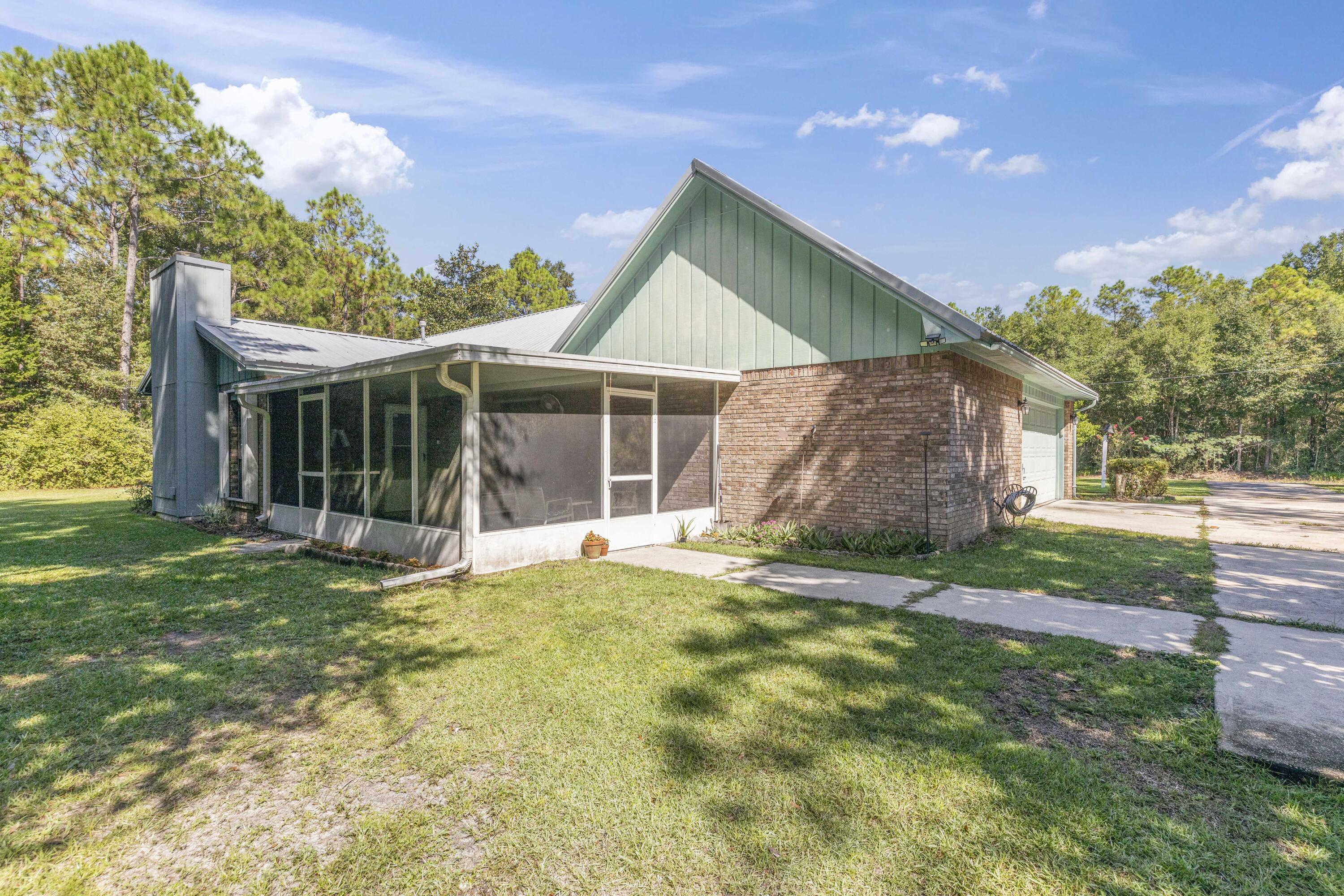 202 Wheeler Place Crestview, FL 32539 - Photo 7 of 40 a view of a house with a yard and sitting area