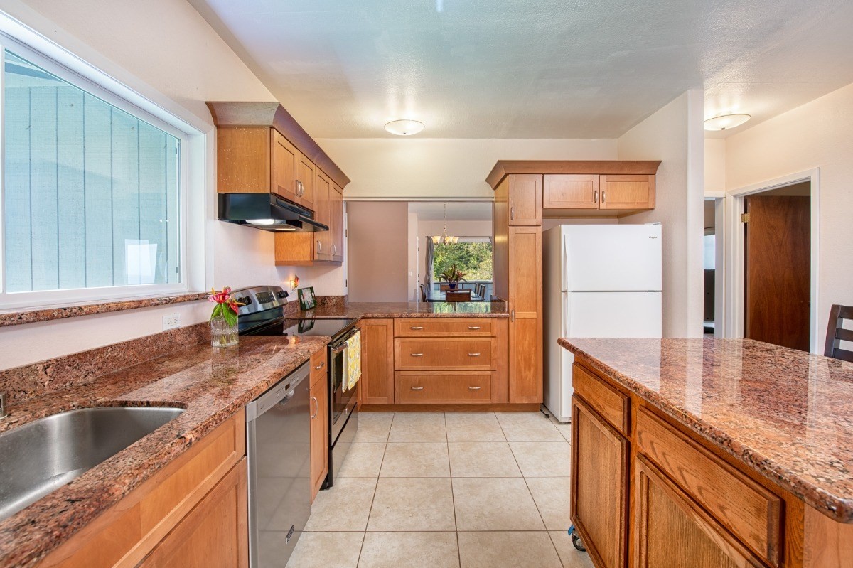44-3265 Kalopa Mauka Road Honokaa, HI 96727 - Photo 11 of 30 a kitchen with a sink stove and cabinets