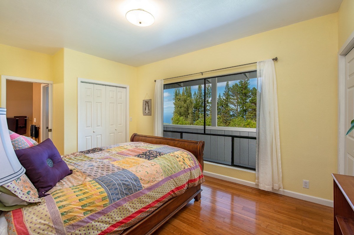 44-3265 Kalopa Mauka Road Honokaa, HI 96727 - Photo 14 of 30 a bedroom with a bed and wooden floor