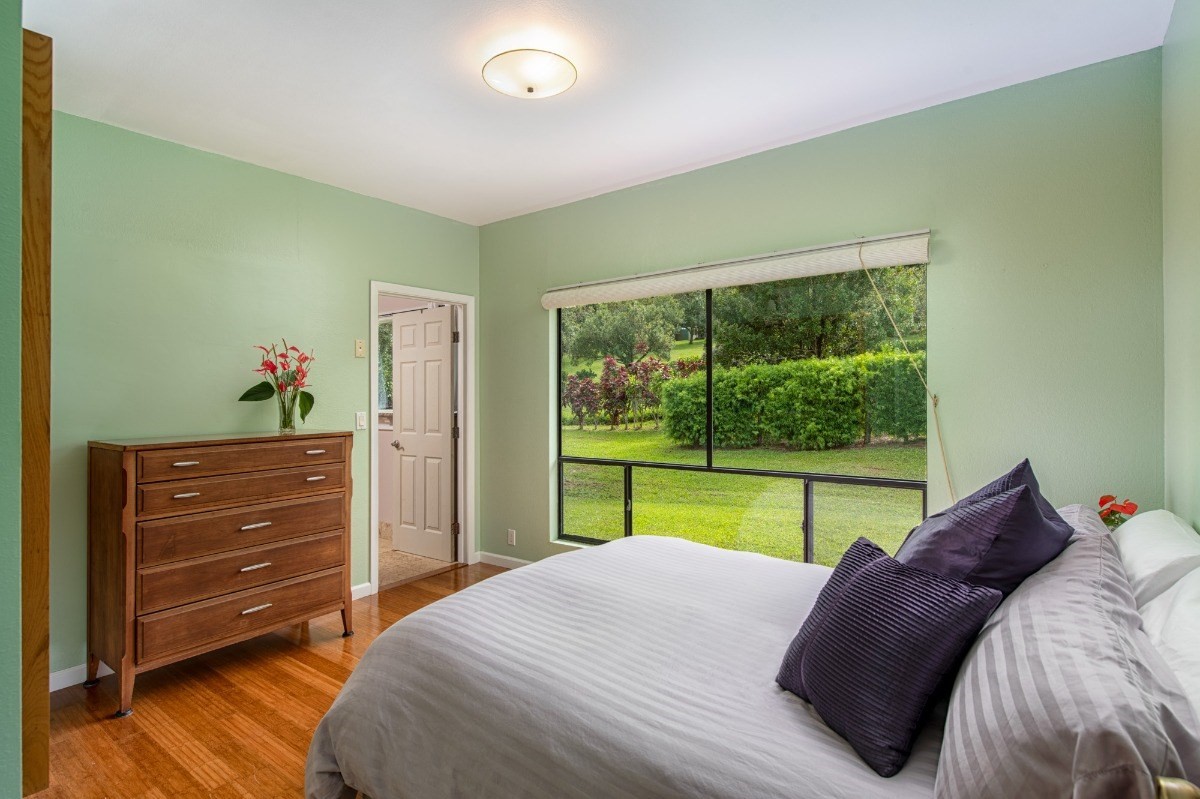 44-3265 Kalopa Mauka Road Honokaa, HI 96727 - Photo 17 of 30 a bed room with a bed and a large window