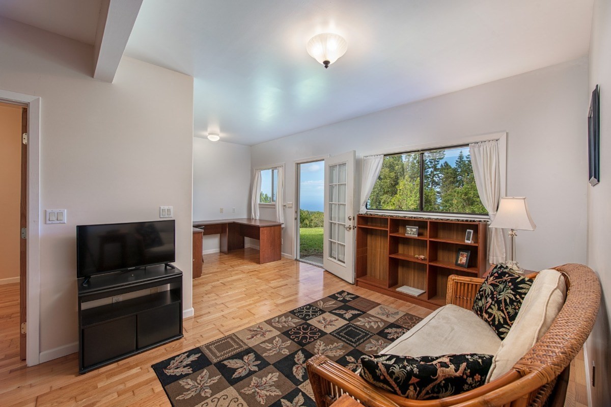 44-3265 Kalopa Mauka Road Honokaa, HI 96727 - Photo 24 of 30 a living room with furniture and a flat screen tv