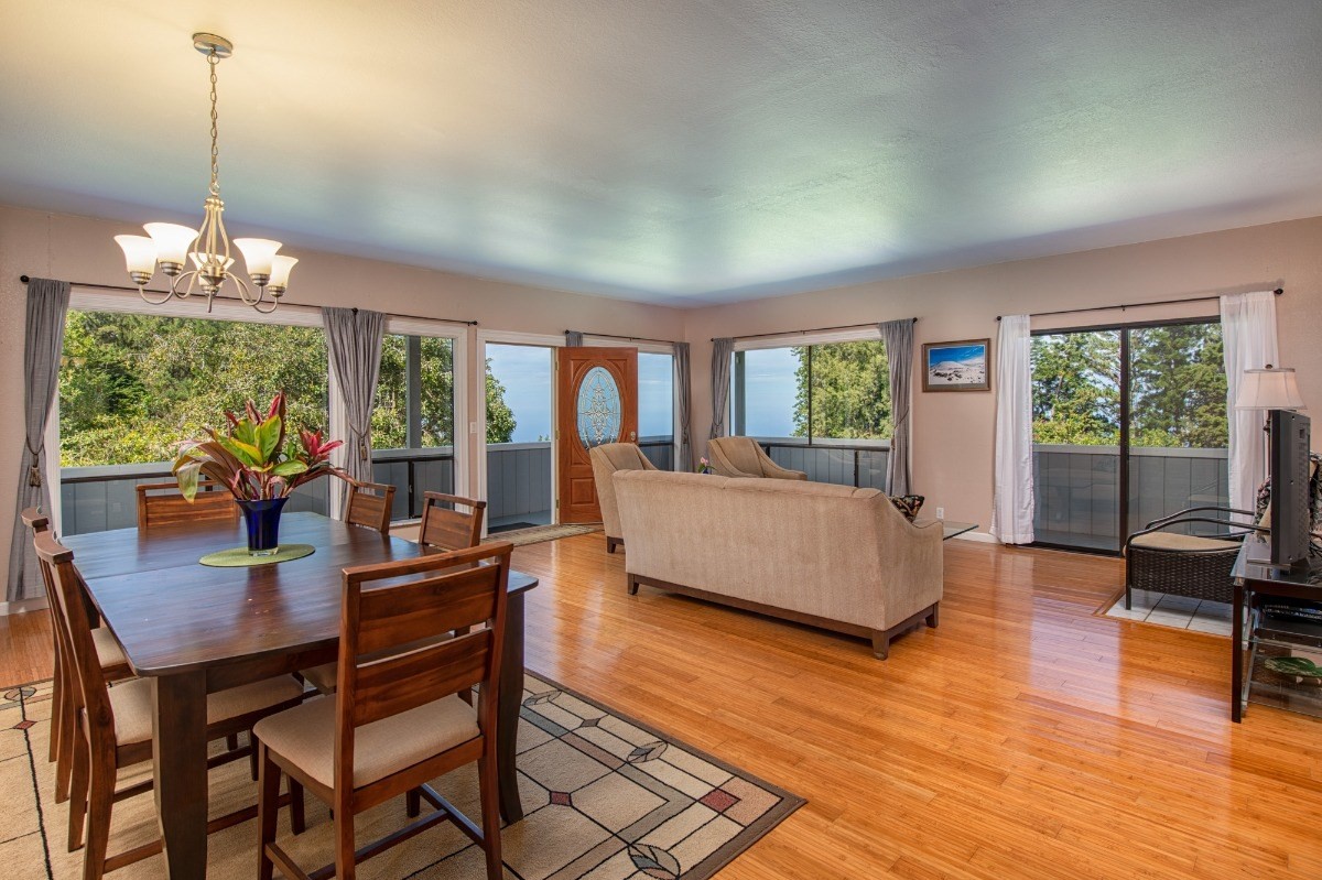 44-3265 Kalopa Mauka Road Honokaa, HI 96727 - Photo 3 of 30 a living room with furniture and a chandelier
