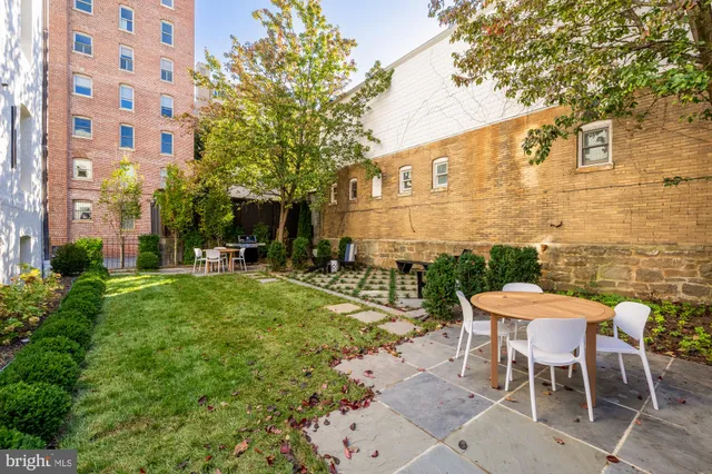 a view of a patio with table and chairs and potted plants