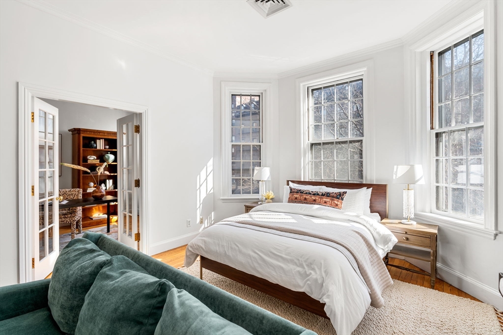 120 Beacon Street, Unit 3 Boston, MA 02116 - Photo 11 of 19 a bedroom with a bed a dresser and a large window